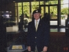Lonny Holmes Wearing LTC Wm Taylors Beret Standing Adjacent to Heisman Trophy of O.J. Simpson in USC\'s Heritage Hall