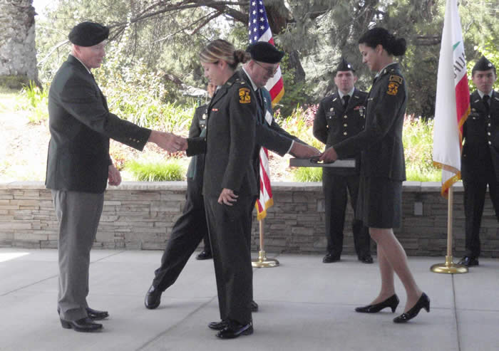 California State University Fullerton ROTC Battalion Professor of Military Science LTC Jonathan B. Nepute, Commanding - Lonny Holmes shaking hands with Cadet Jessica Villanueva, Brad Welker taking Special Forces Medal of Merit for presentation.