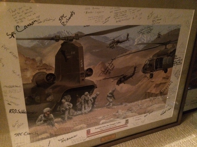 “Assault into the Sangin Valley – ‘That’s What Heroes Do’ ” by Fred Rothenbush — a print given to Alex Quade, signed by some of the men on the op. (Courtesy Alex Quade)