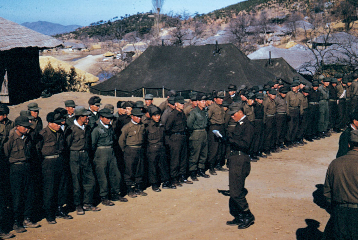Roll call for a guerrilla unit. As 2LT Maurice H. Price found out, the guerrillas would attempt to pad the numbers in formation to get a larger share of the food resupply. (U.S. Army)