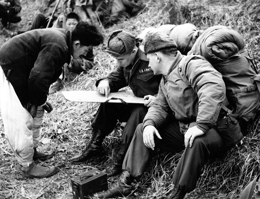 Above left, 2LT Earl L. Thieme (foreground) and an unidentified enlisted man check their map during a reconnaissance northe of Seoul in the winter of 1954.