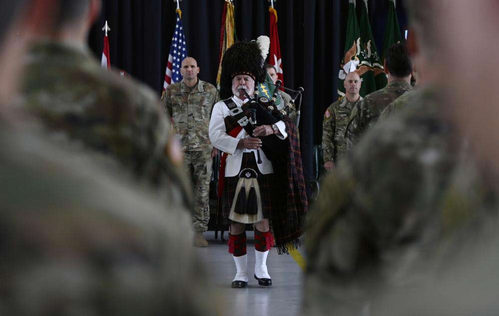 At the SFQC graduaton ceremony, the soldiers march in formation behind bagpiper Doug Ellwell during a Regimental First Formation. (U.S. Army photo by K. Kassens)