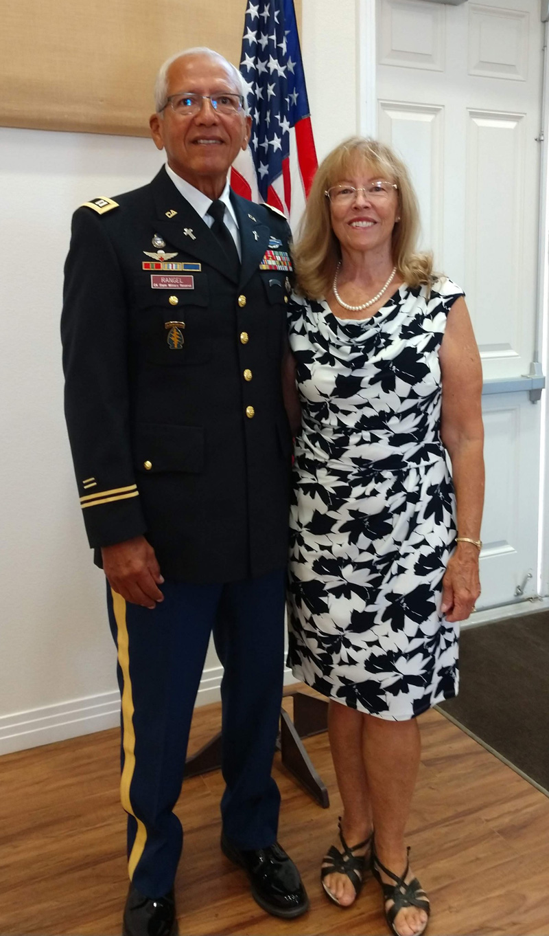 Si Rangel and his wife Christine in front of American flag