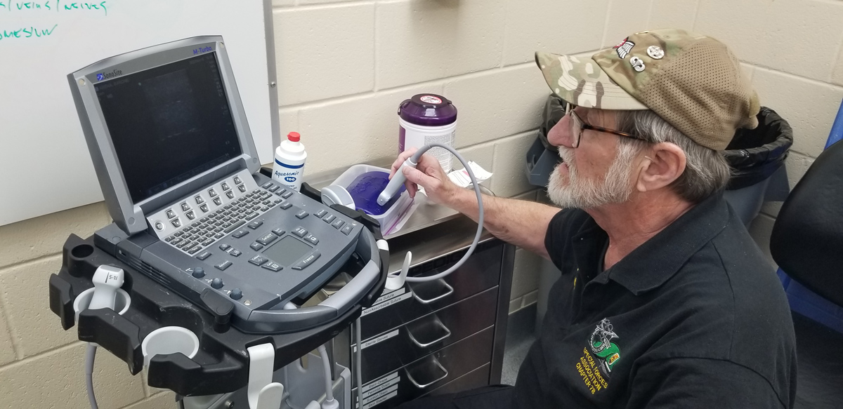 How Miller tries out a sonogram machine. (Lew Chapman)