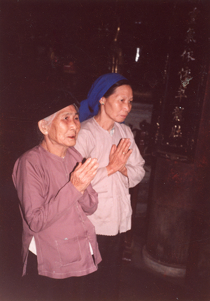 Women praying in a Buddhist temple in Hanoi. (Photo by Marc Yablonka)