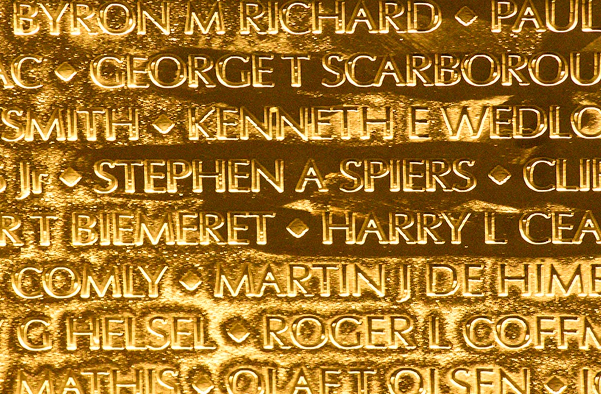 The panel with Stephen A Spiers’ name glows golden in the evening lighting. (Photo by How Miller)