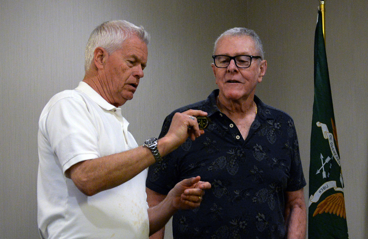 Chapter 78 President John Stryker Meyer presents SFA Executive Director Cliff Newman with the newly designed Chapter 78 challenge coin. (photo by Rick Carter)