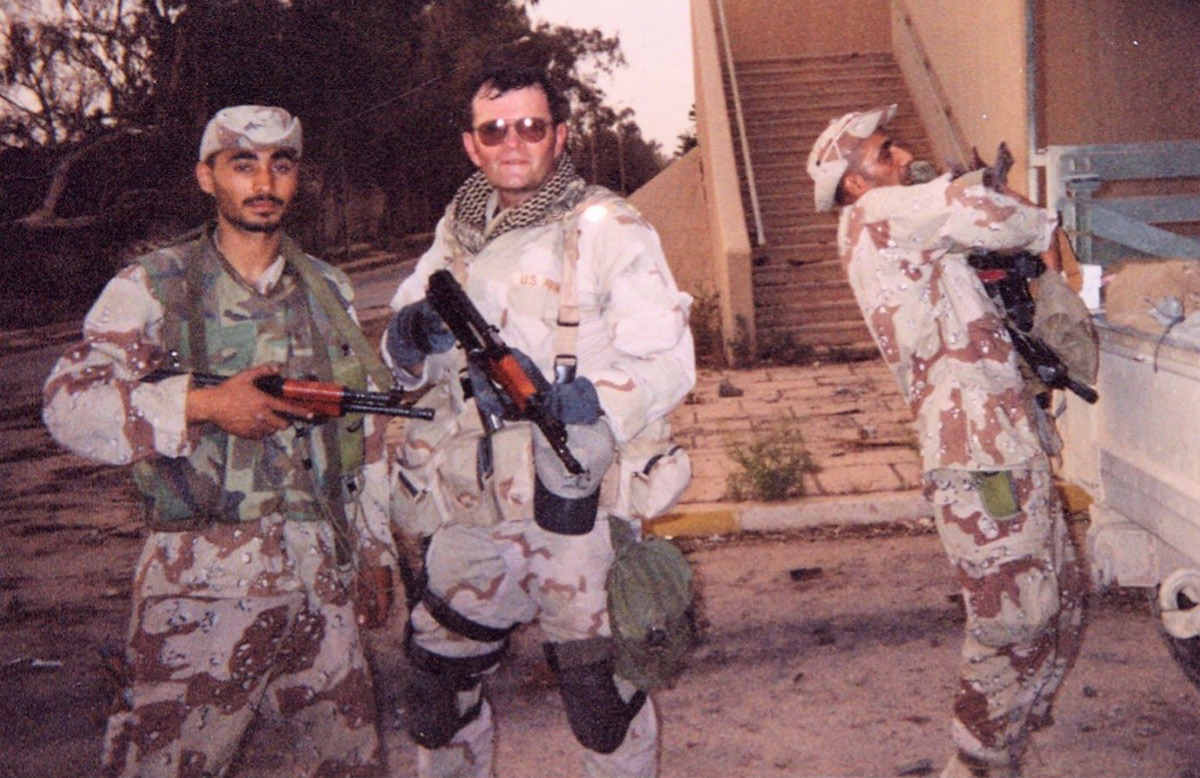 The author with Iraqi freedom fighters as they upload arms and ammunition from one of dozens of Iraqi military armories in Baghdad. (Author Collection)